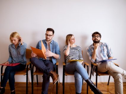 jovens sentados à espera de entrar para entrevista