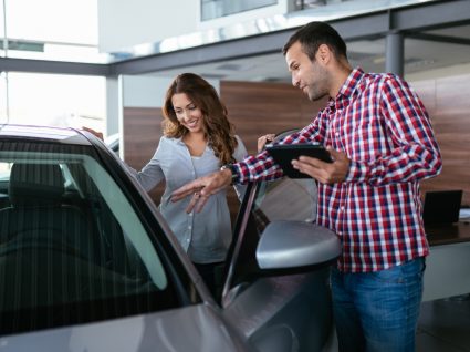 mulher a ver veículo antes de comprar carro usado a um particular