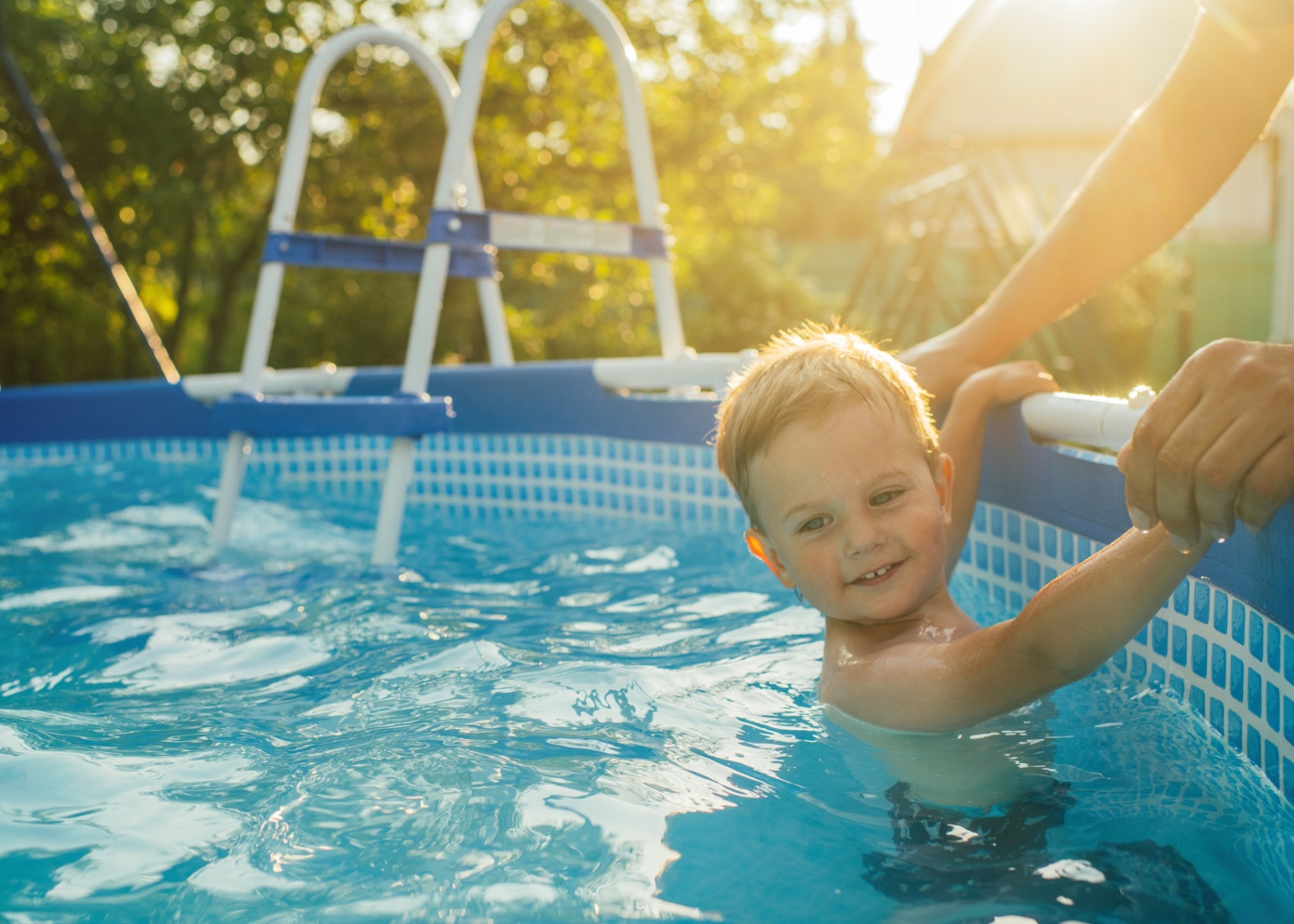 Menino a divertir-se numa piscina desmontável