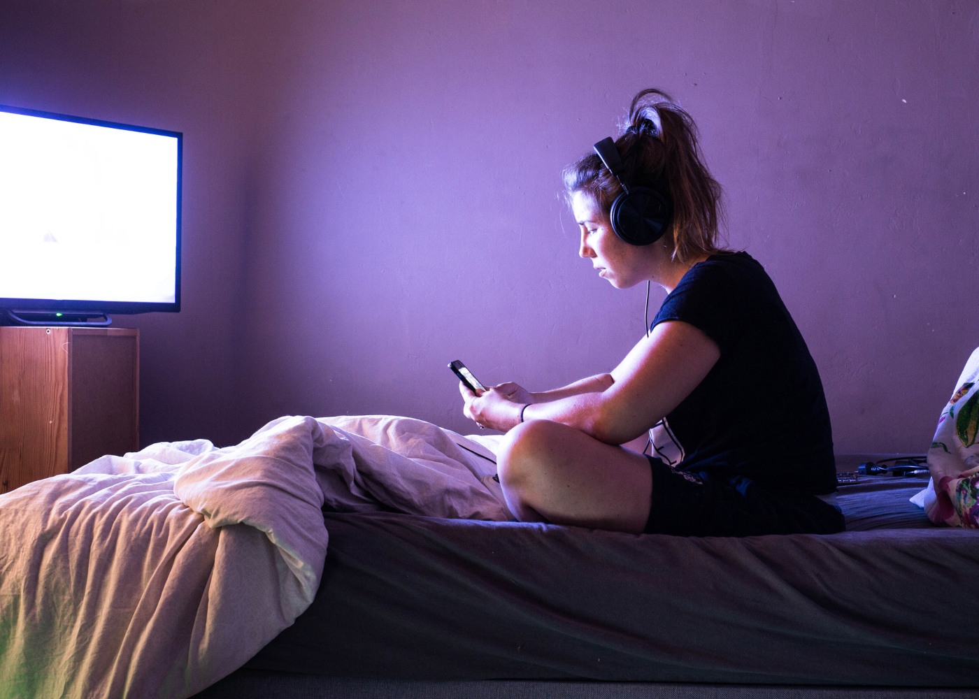 jovem com televisão no quarto